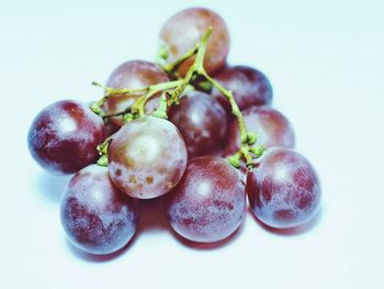 Close-up of grapes against white background