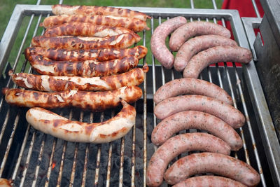 High angle view of sausages on barbeque grill