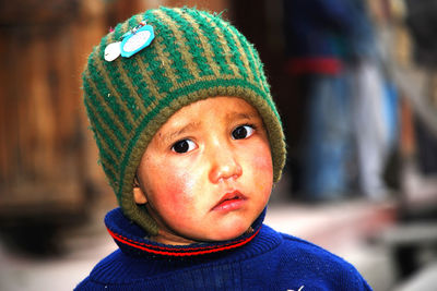 Close-up portrait of boy in park during winter