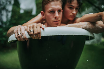 Couple in bathtub outdoors