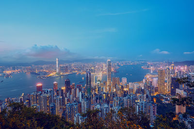 Illuminated buildings in city against sky