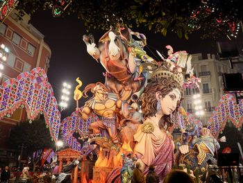 Statue of illuminated christmas lights at night