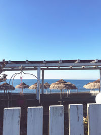 Built structure on beach against clear blue sky