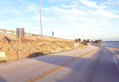 Road by sea against sky in city