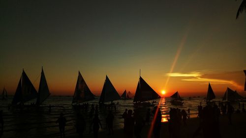 Panoramic view of silhouette beach against clear sky during sunset