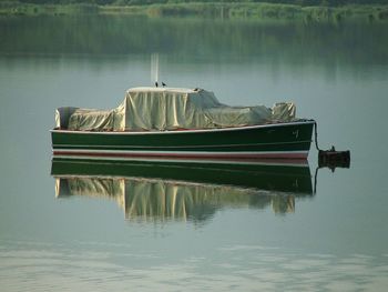 Full length of nautical vessel in reflection lake