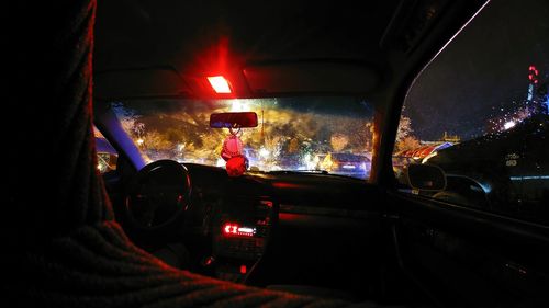 Cars in illuminated tunnel at night during monsoon