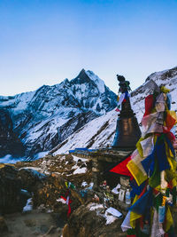 Built structure against snow covered mountains