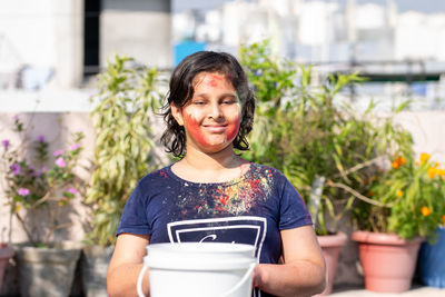 Cute girl with color on face smiling