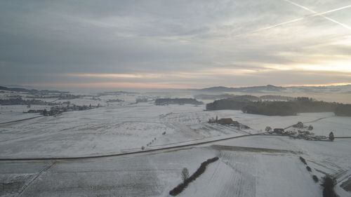 High angle view of snow covered cityscape against sky