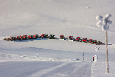 High angle view of vehicles parked on snow covered landscape