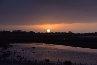 Scenic view of sunset over lake