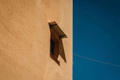 Low angle view of building against clear blue sky