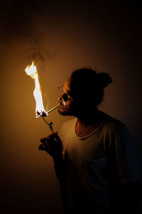 Guy holding burning rose and cigarette 