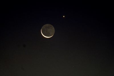 Low angle view of moon against sky at night