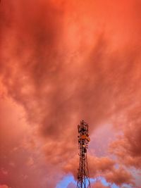 Low angle view of communications tower against sky during sunset