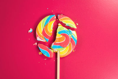 Close-up of multi colored candies against red background