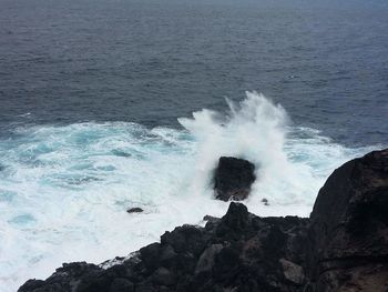 Scenic view of waves in sea against sky