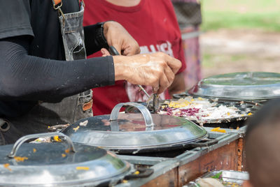 Midsection of man preparing food at restaurant