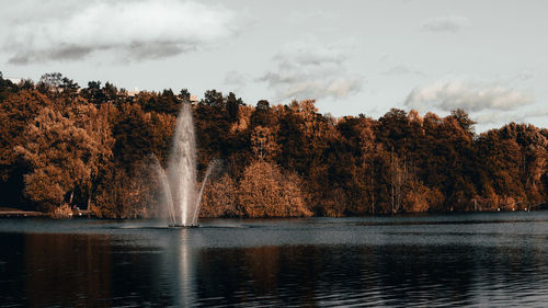 Scenic view of waterfall against sky during autumn