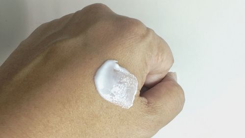 Close-up of human hand against white background