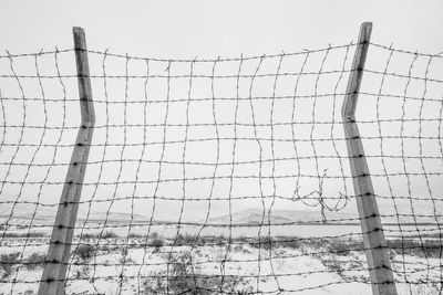 Low angle view of barbed wire against clear sky