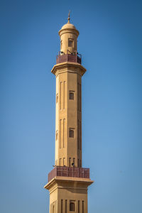 Low angle view of lighthouse against clear blue sky