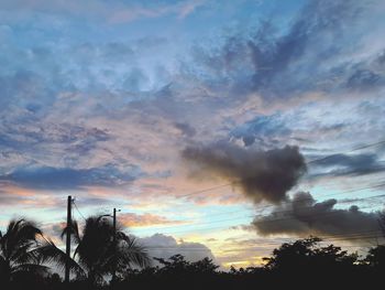 Low angle view of silhouette trees against sky during sunset