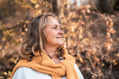 Mid adult woman looking away in forest