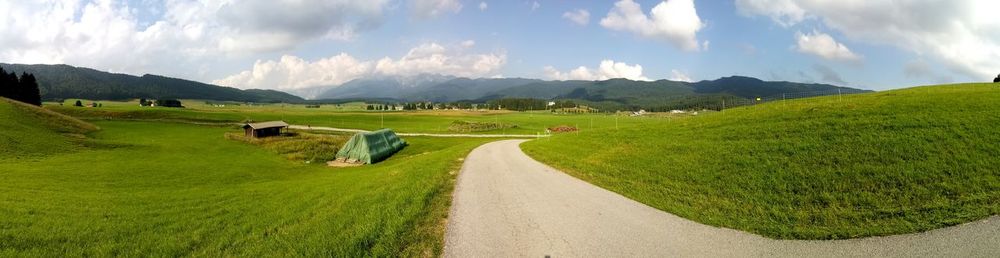 Panoramic view of green landscape against sky