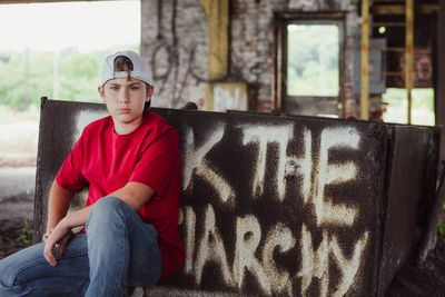 Full length portrait of boy sitting outdoors