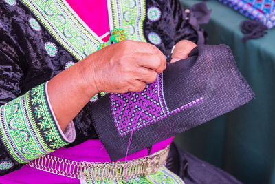 Midsection of woman holding umbrella