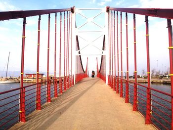 Rear view of man on bridge against sky