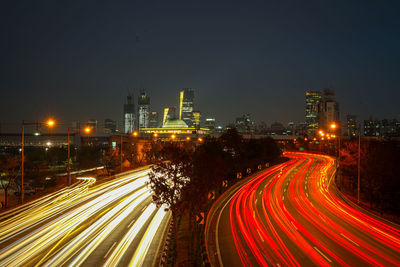 High angle view of light trails on road at night