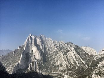 Panoramic view of mountains against clear blue sky