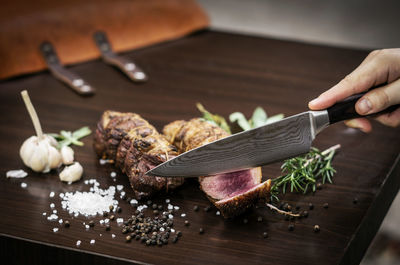 Close-up of person preparing food on cutting board