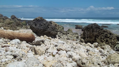 Rocks on beach against sky