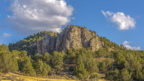 Low angle view of rock formations against sky