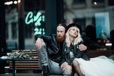 Young couple sitting outdoors