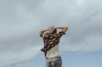 Low angle view of man standing against sky