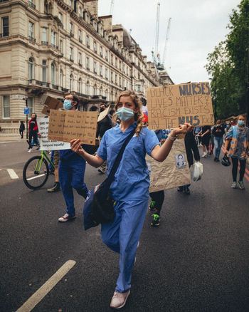 GROUP OF PEOPLE WALKING ON ROAD