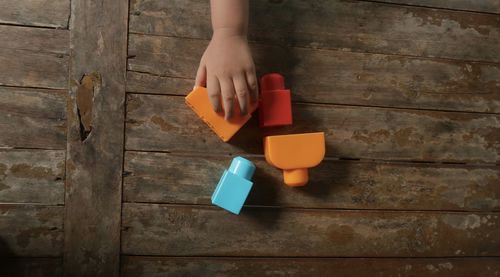 Midsection of woman holding ice cream on table