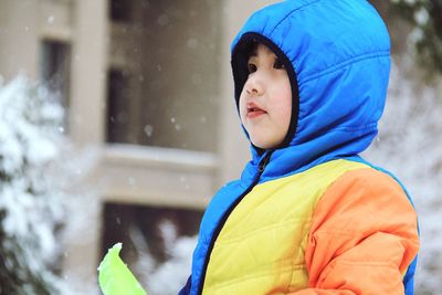 Close-up of cute boy in warm clothing outdoors