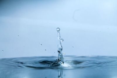 Close-up of water splashing against sky