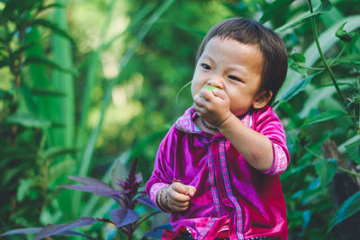 Portrait of cute girl standing outdoors