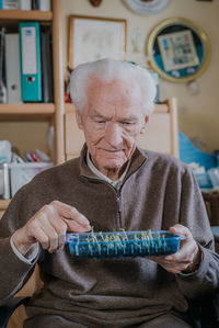 Senior man holding potted plants