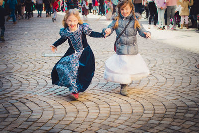 Portrait of girls in costume on city street