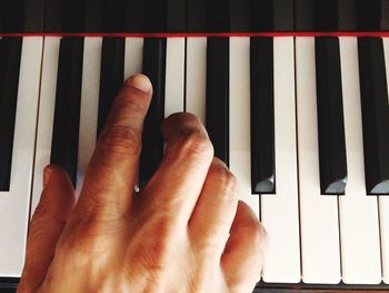 Close-up of hands playing piano