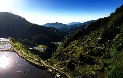 Scenic view of mountains against blue sky