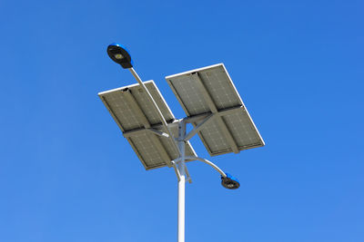 Low angle view of street light against clear blue sky